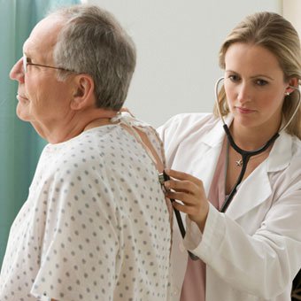 doctor examining a patients lungs